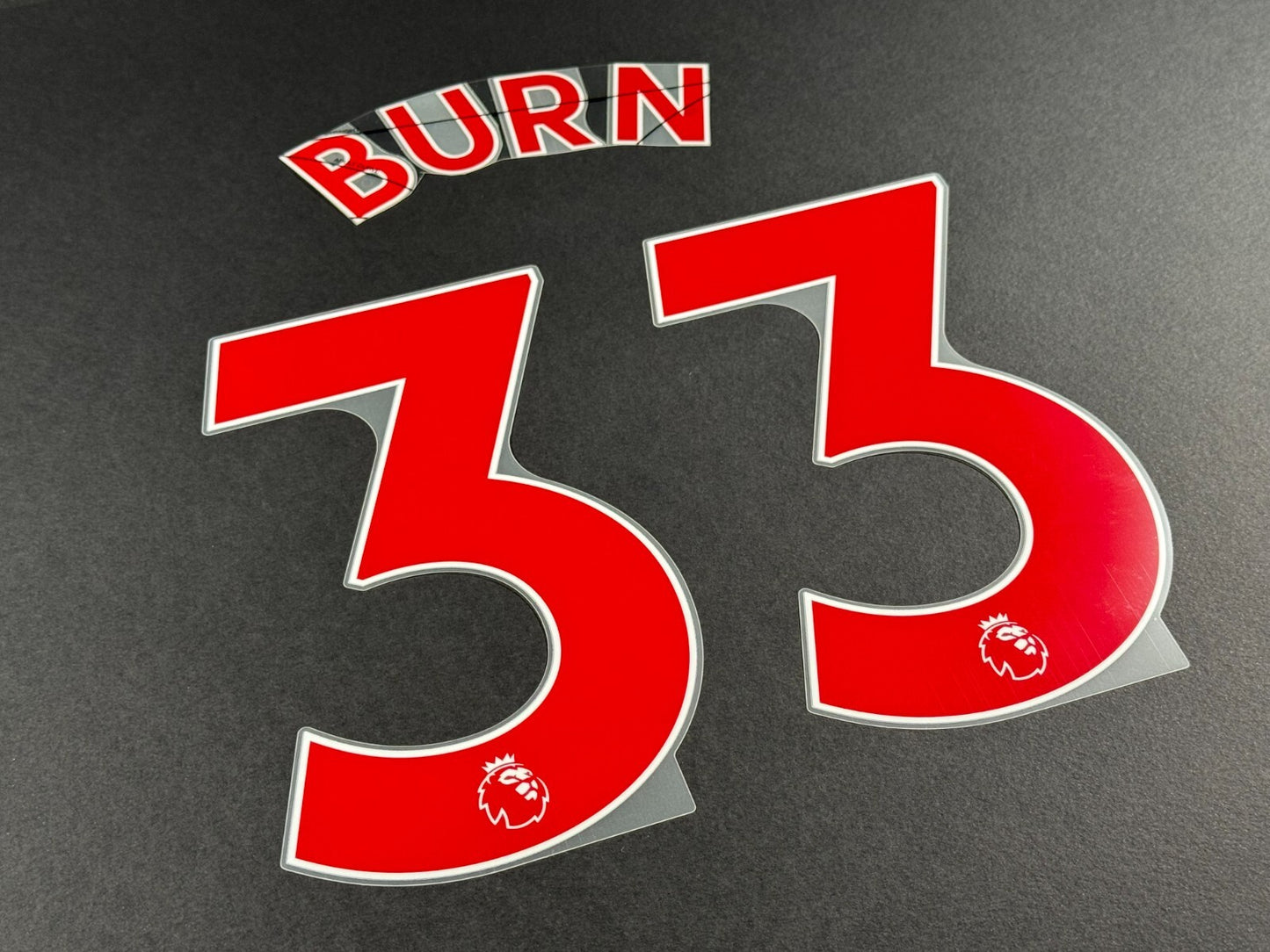 NEWCASTLE 2022-23 BURN 33 OFFICIAL AVERY DENNISON RED PLAYER SIZE NAME SET
