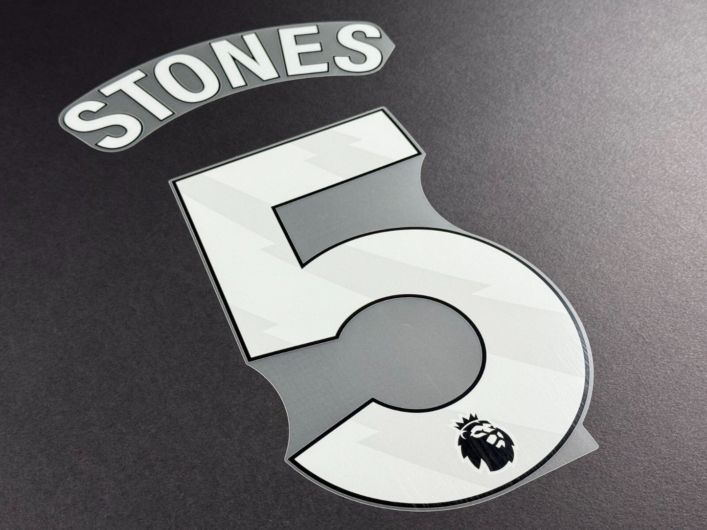 MAN CITY 2024-25 STONES 5 OFFICIAL AVERY DENNISON WHITE PLAYER SIZE NAME SET
