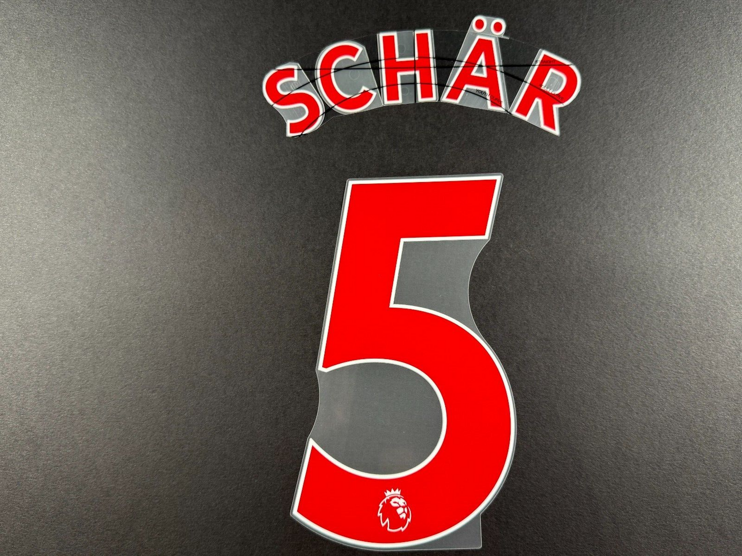 NEWCASTLE 2022-23 SCHAR 5 OFFICIAL AVERY DENNISON RED PLAYER SIZE NAME SET