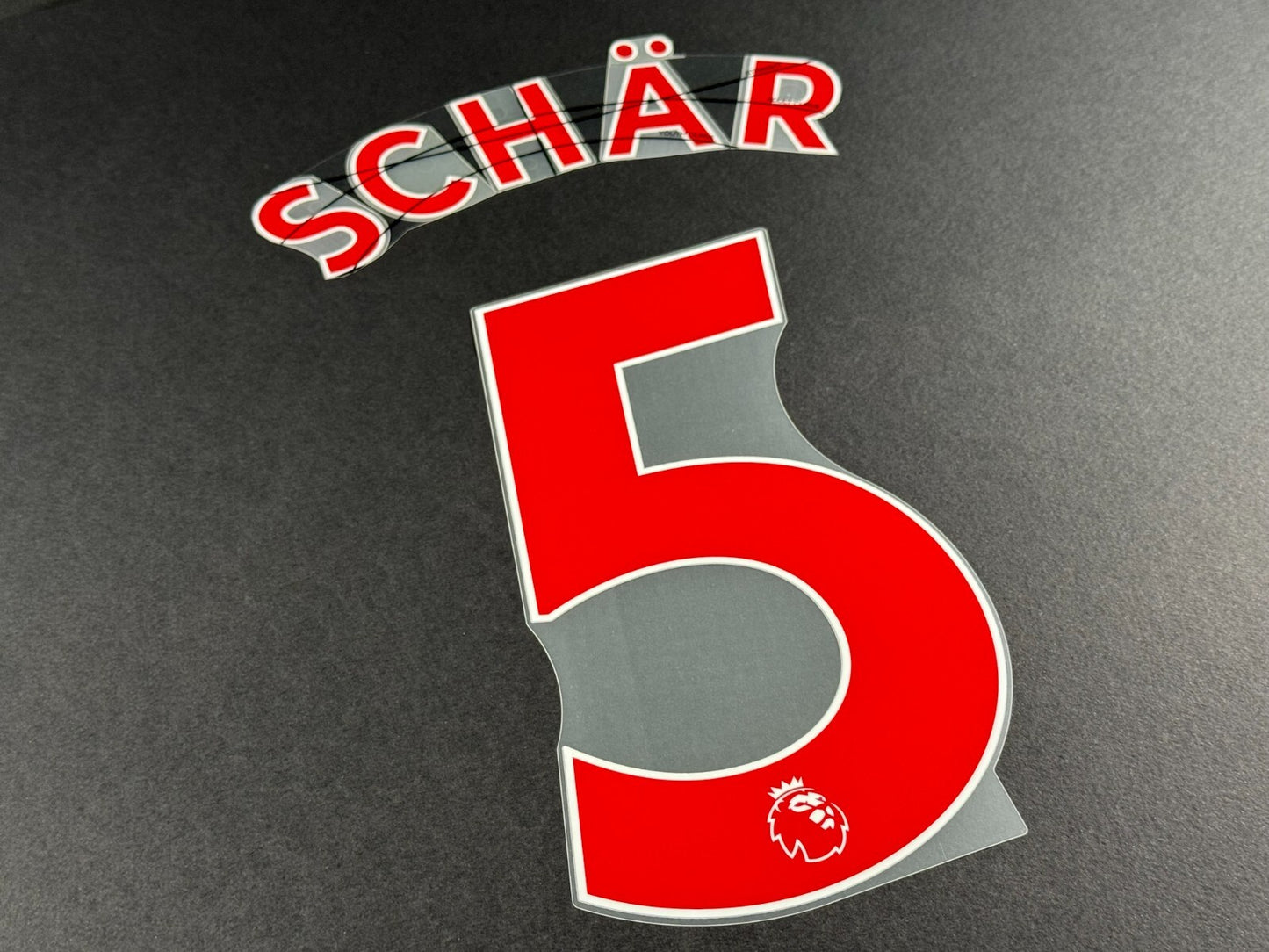 NEWCASTLE 2022-23 SCHAR 5 OFFICIAL AVERY DENNISON RED PLAYER SIZE NAME SET