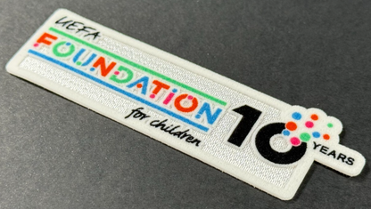 2025 / 2026 SPORTING ID UEFA FOUNDATION 10 YEARS PLAYER SLEEVE PATCH 100MM