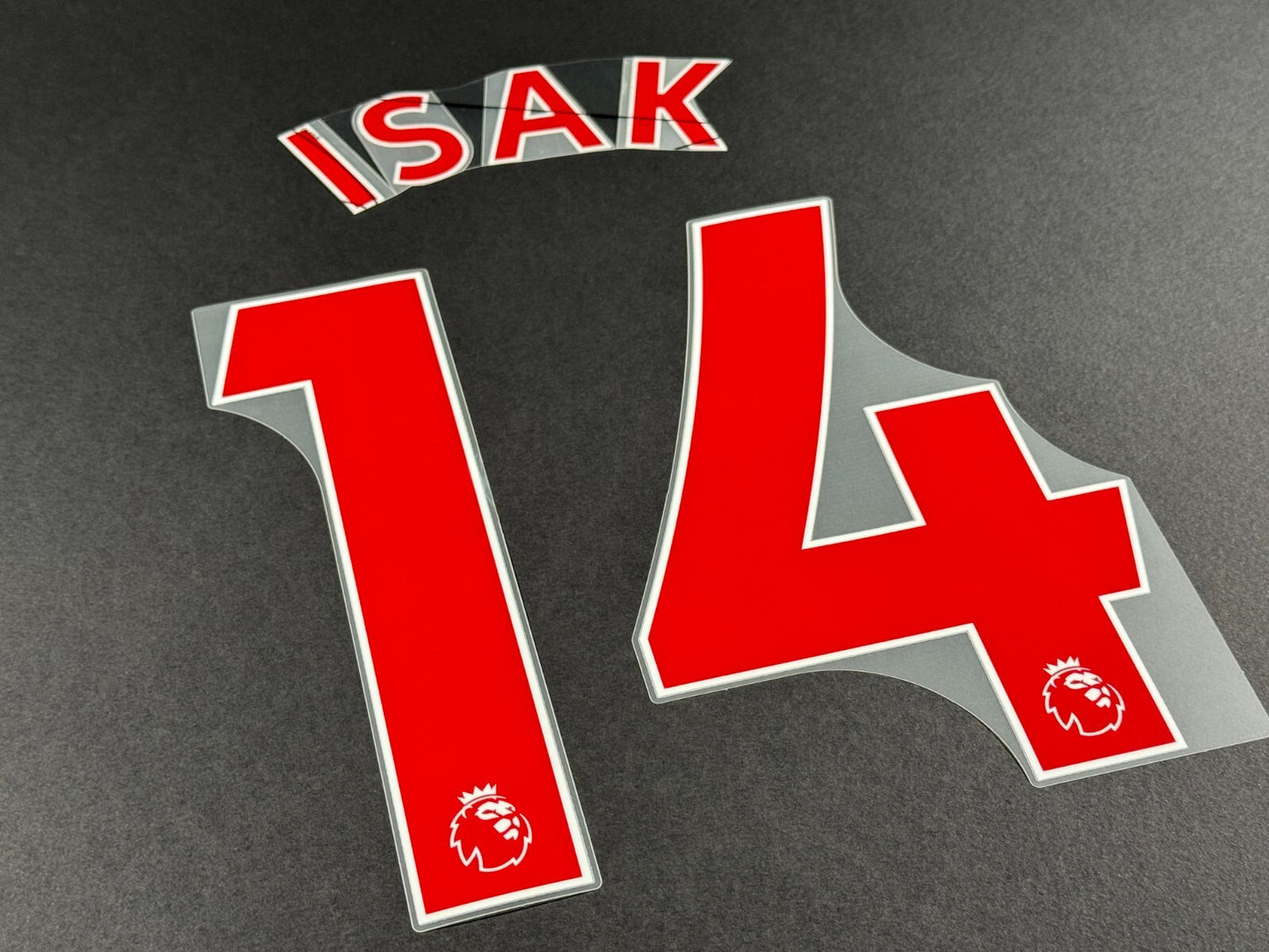 NEWCASTLE 2022-23 ISAK 14 OFFICIAL AVERY DENNISON RED PLAYER SIZE NAME SET